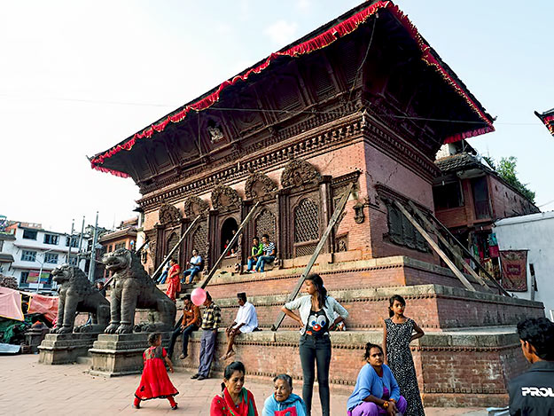 Shiva and his consort still look down on Kathmandu's Durbar Square from a high window in the Shiva Prabati temple, though ittoo is shored up with wooden beams to prevent further damage