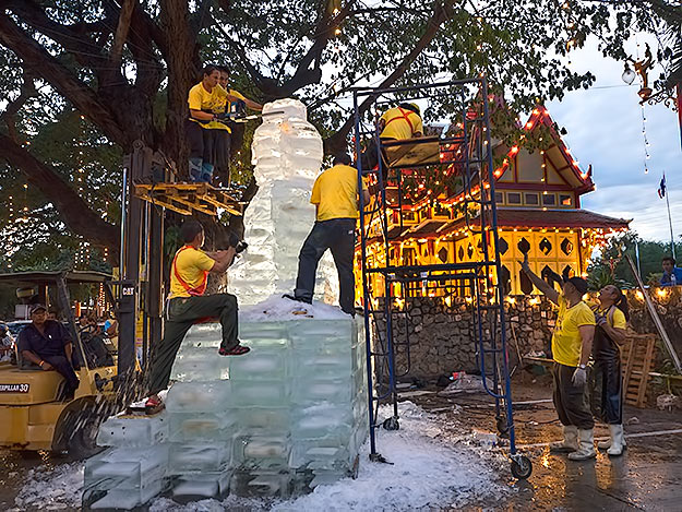 In Hua Hin, Thailand, a crew of world renowned ice sculptors carve what they claim is the tallest statue of Buddha ever made in ice, during the celebration of the King's 88th birthday