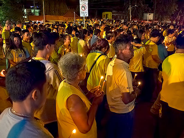 Residents of Hua Hin gather for a candlelight ceremony to honor their King on the occasion of his 88th birthday