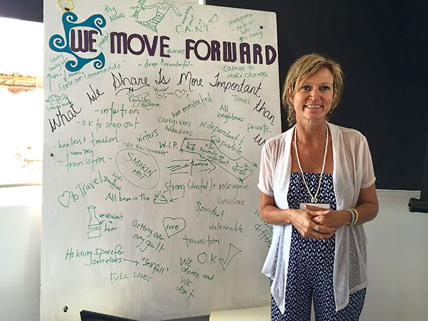 Founder Janeen Halliwell writes down the things we share as women on an easel during an exercise at the We Move Forward Conference