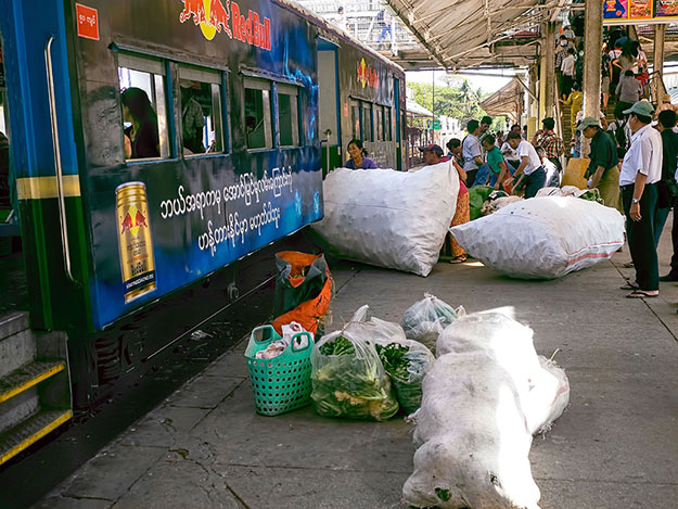 Huge bags are loaded onto the Circular Train at Yangon Central Station