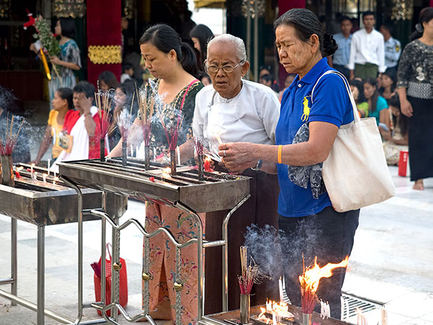 Buddhist worshipers light candles at Shwedagon Pagoda in Yangon, Myanmar