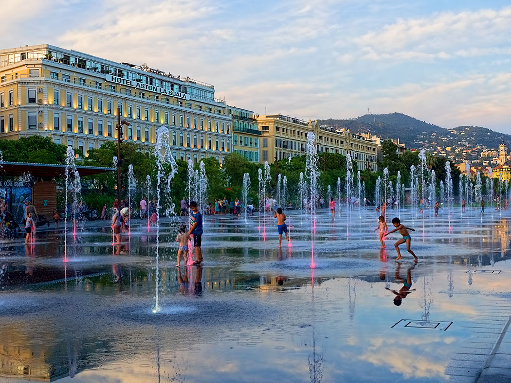 Children romp in the fountain at Promenade du Paillon in Nice, France