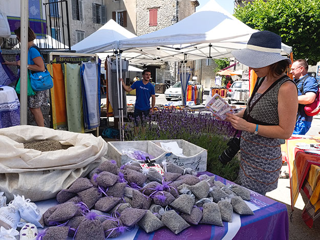 Lavender sachets are heaped on a table at the weekly market in Sault