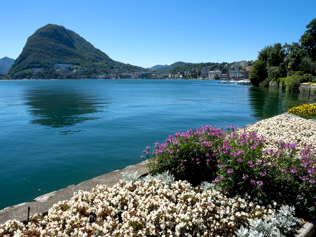 Monte San Salvatore rises on one side of the crescent bay where the town of Lugano, Switzerland graces the shores of Lake Lugano