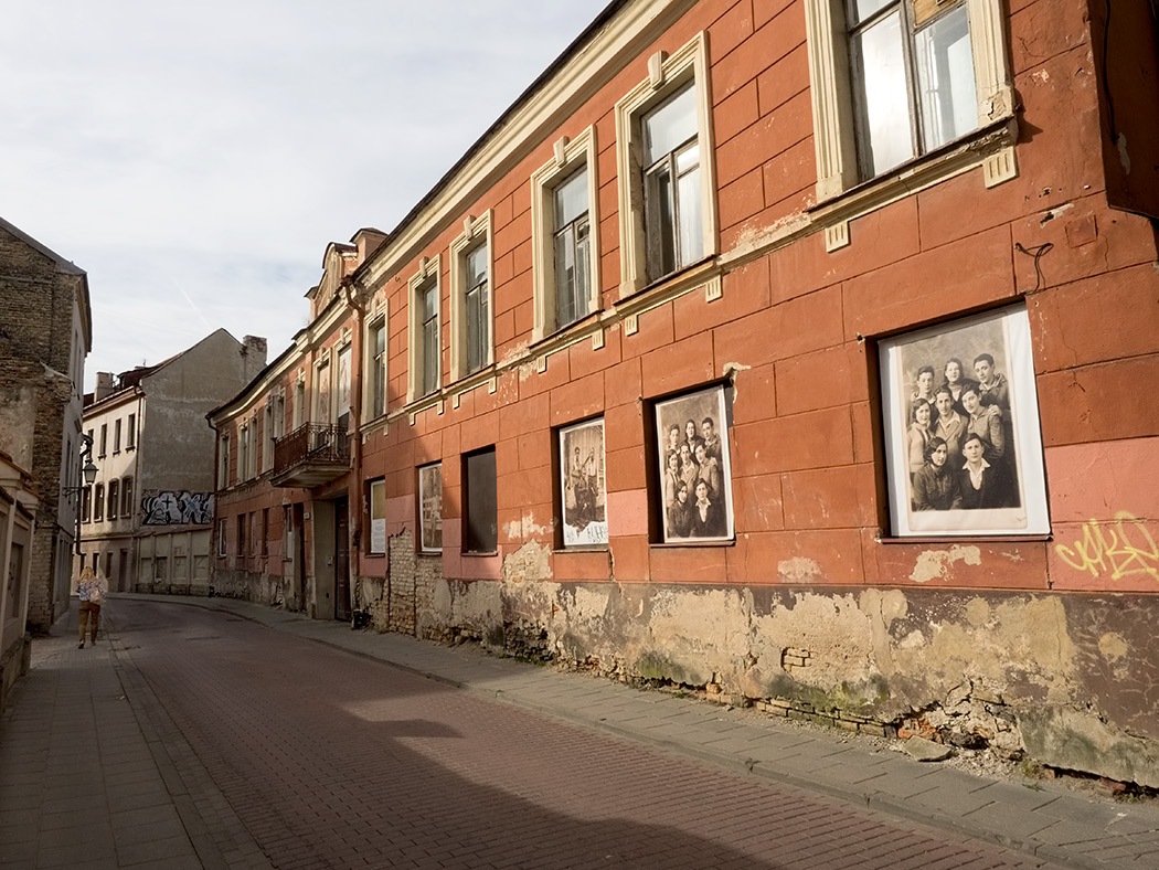 Street in old Jewish ghetto of Vilnius, Lithuania, displays pre-WWII photos of Jewish families who once lived there