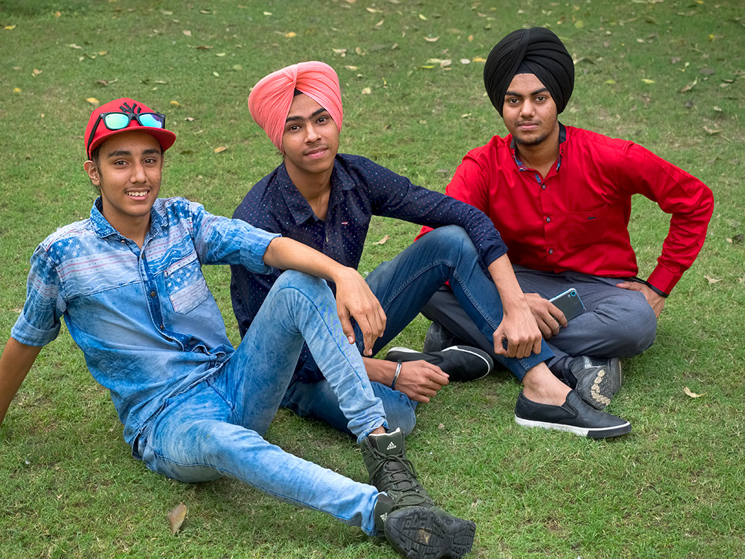 Young men relax on the grounds of the Hauz Khas Archeological Site in South Delhi, India