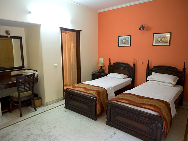 Twin bedroom, one of three bedrooms in the family suite at Prakash Kutir B&B, is equipped with air conditioning, LCD TV, in-room wifi, and ensuite bathroom. It also has a private balcony.