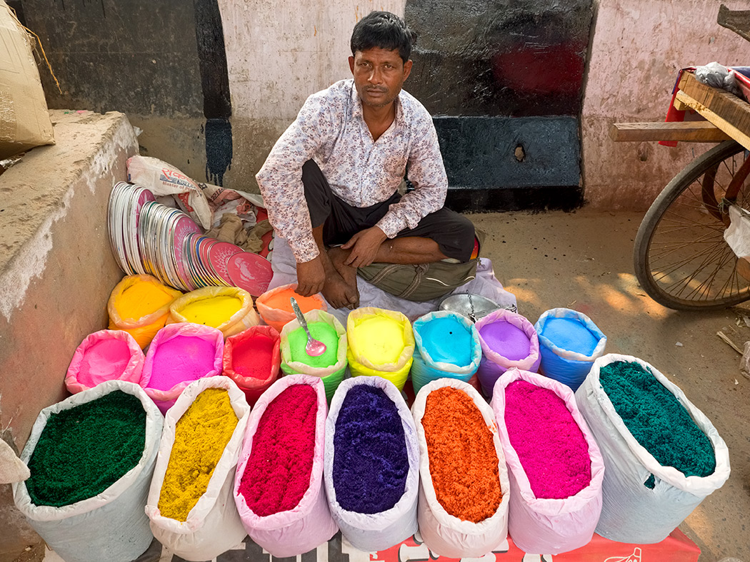 Vendor sells colored powder for Diwali celebrations at the Lajpat Nagar Central Market in Delhi, India
