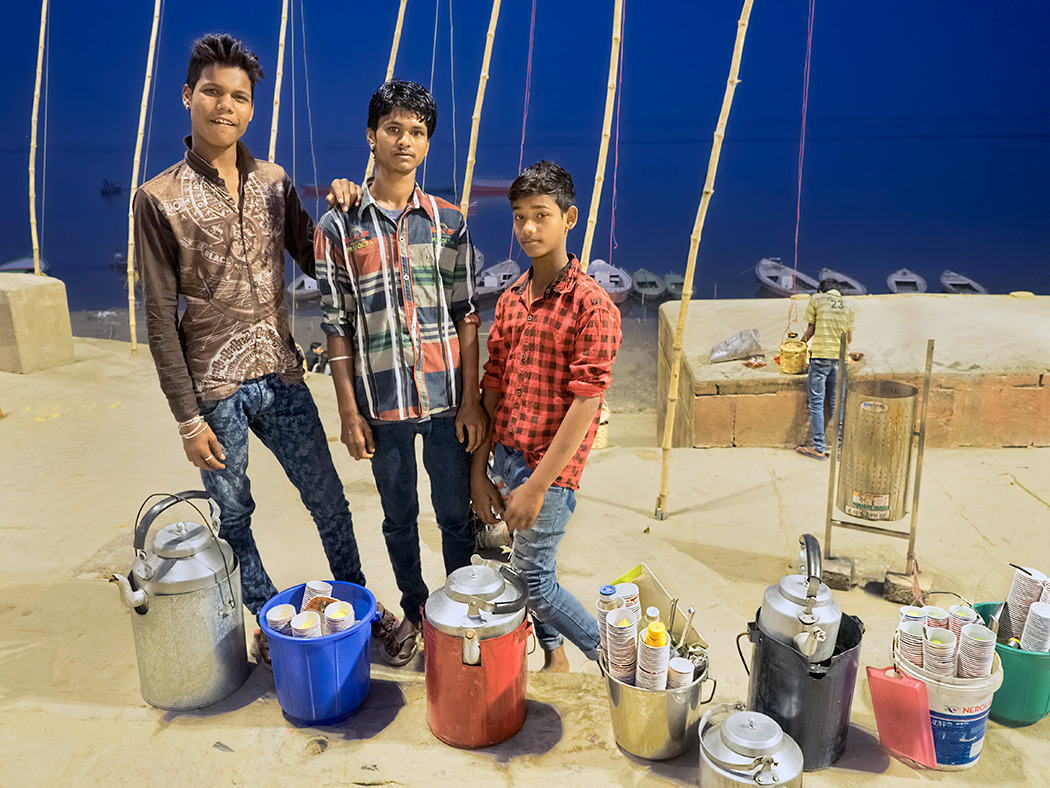 Boys at Assi Ghat in Varanasi, India, prepare to sell food and drinks to visitors who come to the ghat for the evening Fire Purifying Ceremony