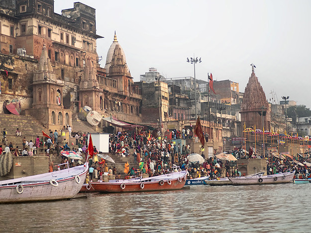 Pilgrims gather at the Varanasi ghats to immerse in the Ganges River