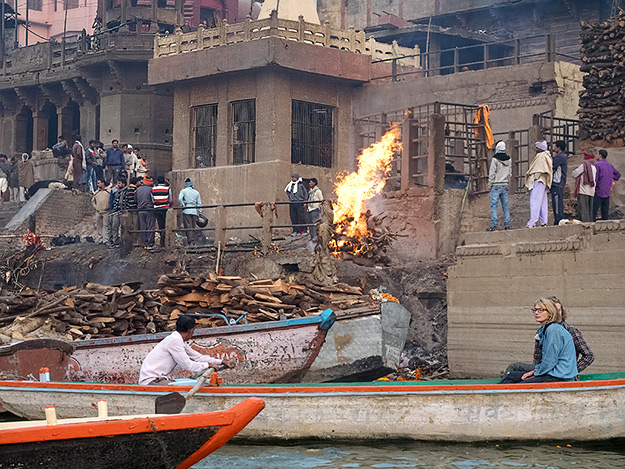 Funeral pyres blaze as bodies are cremated at one of the cremation ghats in Varanasi