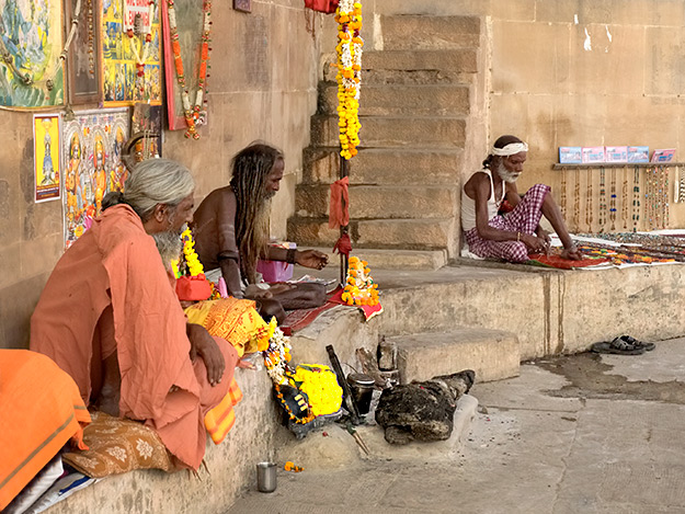 Sadhu holy men pray on the banks of the Ganges River