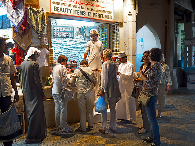 Shop owner in the Mutrah Souk hawks his goods