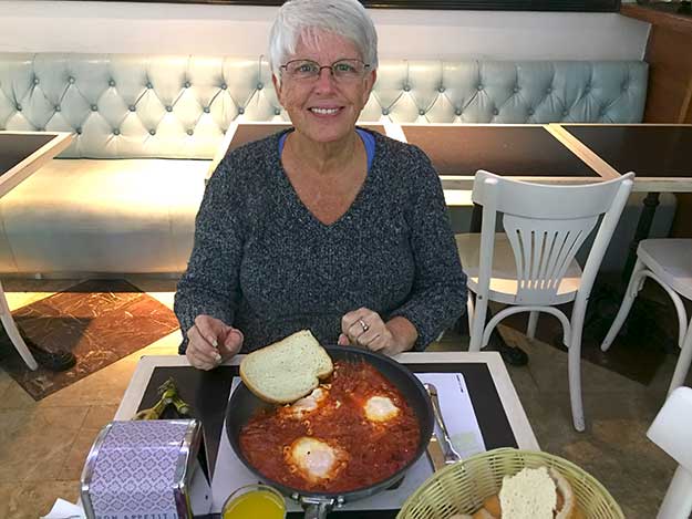 I enjoy a mainstay of Israeli food - a breakfast of Shakshuka, which consists of eggs poached in a slight spicy sauce of tomatoes, chili peppers, and onions