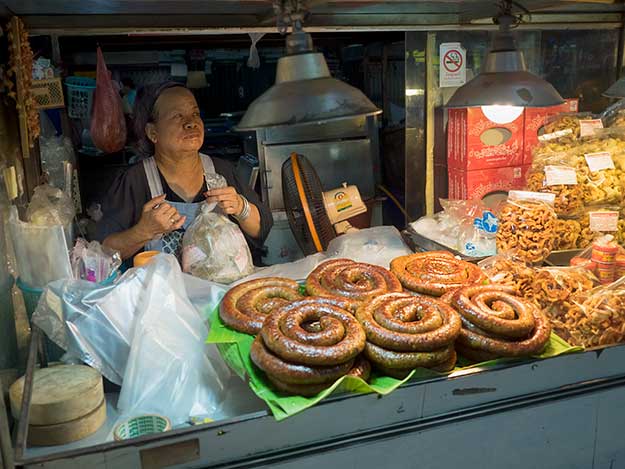 The sausage lady is one of very few vendors inside the open-air hall at Chiang Mai Gate who is open during the morning fresh market and the night food market