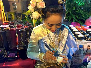 This woman at the Sunday night Walking Street Market in Chiang Mai is demonstrating the art of soap carving in Thailand