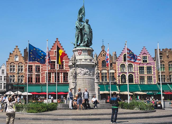 Market Square in Bruges, Belgium, with statue of Jan Breydel and Pieter De Coninck in front of old Guild Houses