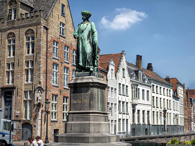 Jan van Eyck statue on Jan van Eyckplein at the end of Spiegelrei Canal in Bruges is one of the quieter areas in the city center