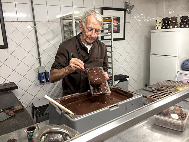 At the Museum of Cacao and Chocolate in Brussels, Belgium, chocolatier Henry Snackers pours chocolate into a mold