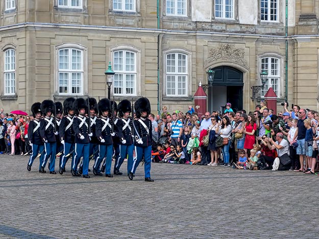 Families with kids watch the changing of the guard ceremony at Amalienborg Palace