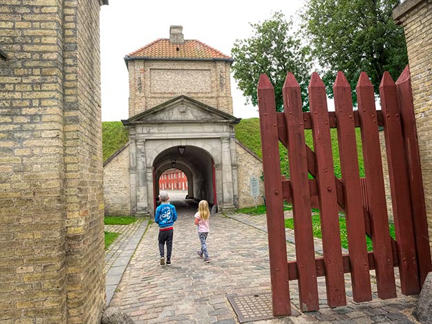 Kids walk toward the entrance of Kastellet Fortress, one of the best preserved star fortresses in Northern Europe