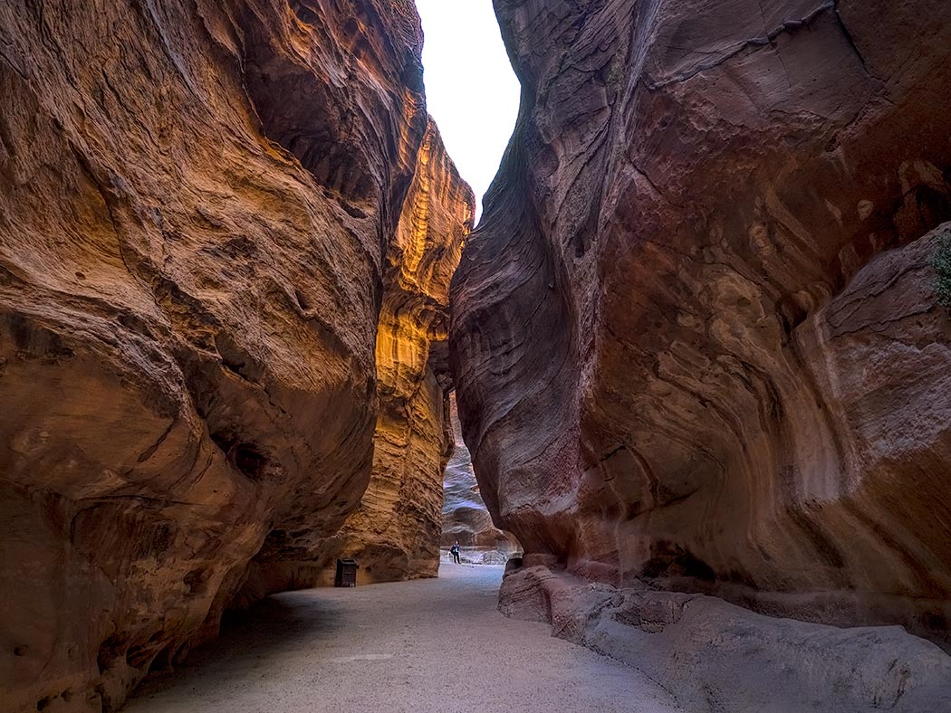 In the late afternoon sun Al Siq, a slot canyon that leads to the archeological site of Petra, Jordan, bursts into flaming reds and golds