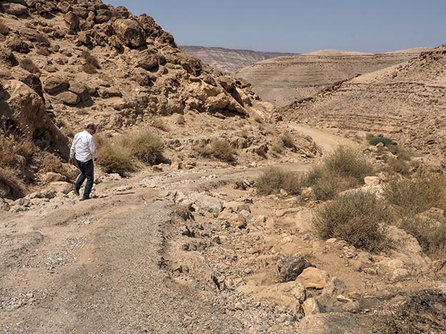 My driver gets out of the car to examine the rough road before attempting to drive over it. This was definitely not on my list of preferred places to visit in Jordan.