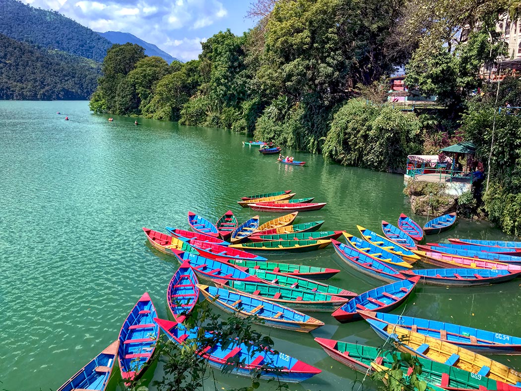 Colorful wooden boats on Phewa Lake in Pokhara, Nepal