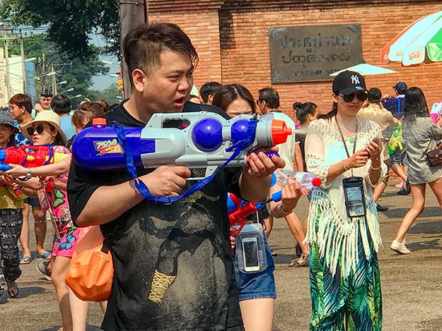 Man drenches revelers with water canon during 2018 Songkran Festival in Chiang Mai, Thailand
