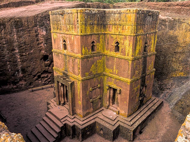 Priest in Bet Danaghel Church holding the Cross of King Lalibela. The  rock-hewn churches of Lalibela make it one of the greatest  Religio-Historical sites not only in Africa but in the Christian