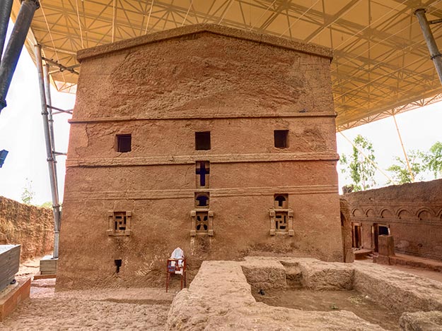 Priest in Bet Danaghel Church holding the Cross of King Lalibela. The  rock-hewn churches of Lalibela make it one of the greatest  Religio-Historical sites not only in Africa but in the Christian