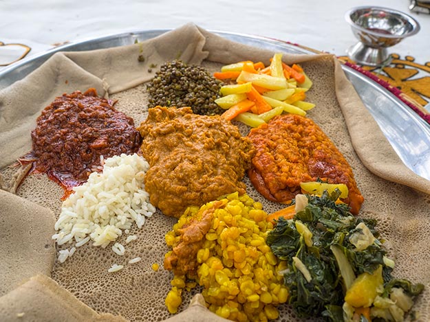 Fasting Yetsom Beyaynetu platter served on a huge sheet of Injera, the very best of Ethiopian food