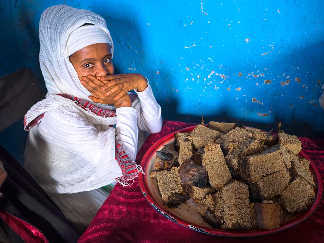 This young girl was responsible for distributing fresh-baked bread to guests at an Ethiopian wedding in Lalibela, Ethiopia, to which I received an impromptu invitation when I walked by