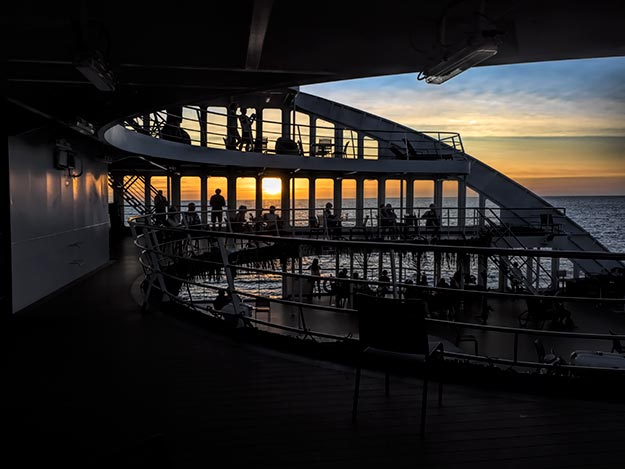 Happy hour on board the Aranui 5 as the sun sinks slowly toward the horizon