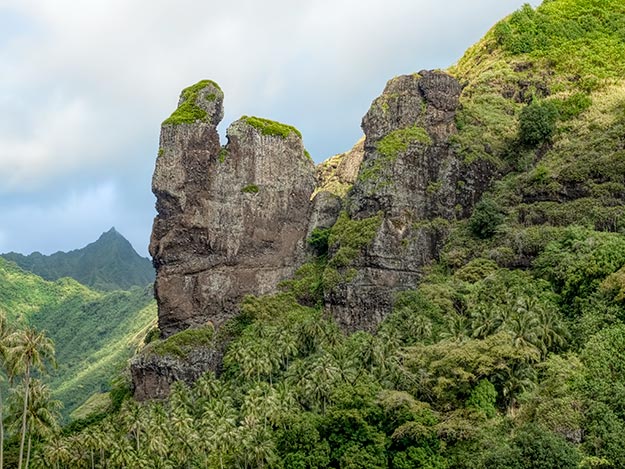 The Virgin rock formation looms over the village of Hanavave on the Marquesan island of Fatu Hiva