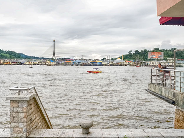 Boat landing on the Brunei River in Bandar Seri Begawan. From here visitors can hire a boat to visit Kampong Ayer, an entire neighborhood of houses built on stilts over the water, see in in the distance. 