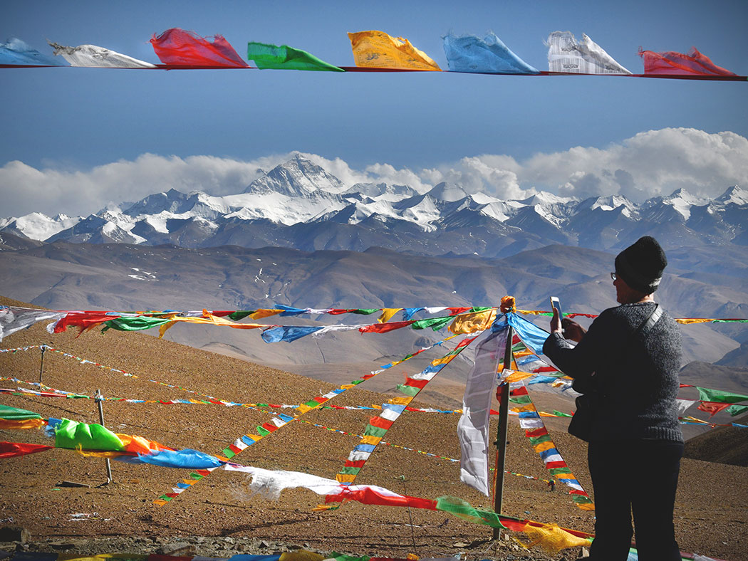 Barbara Weibel taking photo of Mount Everest at Geu La Pass in Tibet China