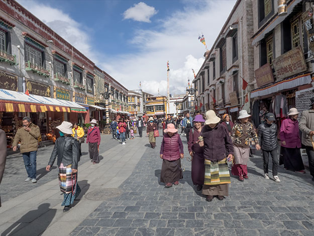 Pilgrims perform a Kora - a clockwise circumambulation of Jhokhang Temple, one of the most revered holy sites in Lhasa, Tibet 