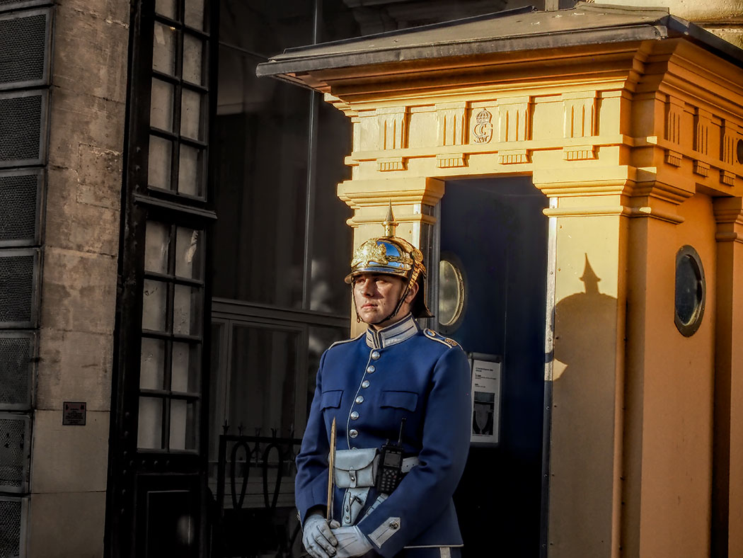 Member of the Swedish Royal Guards stands at the entrance to the Royal Palace in Stockholm, Sweden