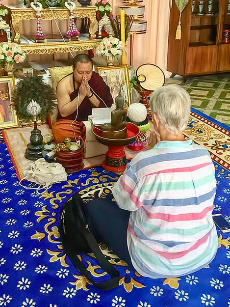 Phrapalad Thanwa reads from Buddhist scriptures during the Buddha statue consecration ceremony