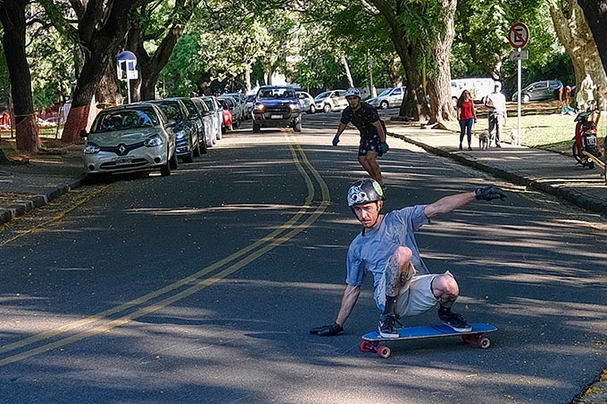 Skateboarders take advantage of the downward slope of Republica del Libano Avenue in Plaza Mitre