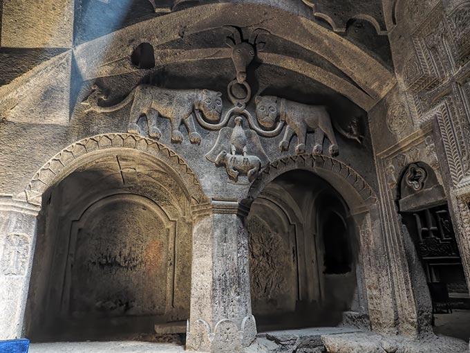 Visiting Armenia - Detailed images carved from solid stone inside Geghard Cave and Monastery in the Armenian countryside