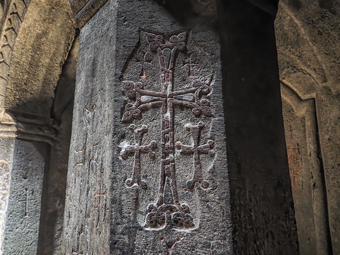 Visiting Armenian crosses carved into Geghard Cave Monastery were believed to have the power to save a soul