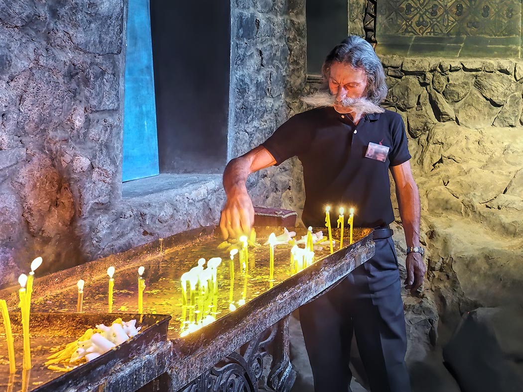 Pilgrim lights a candle in St. Astvatsatsin Chapel at Khor Virap Sanctuary in Armenia