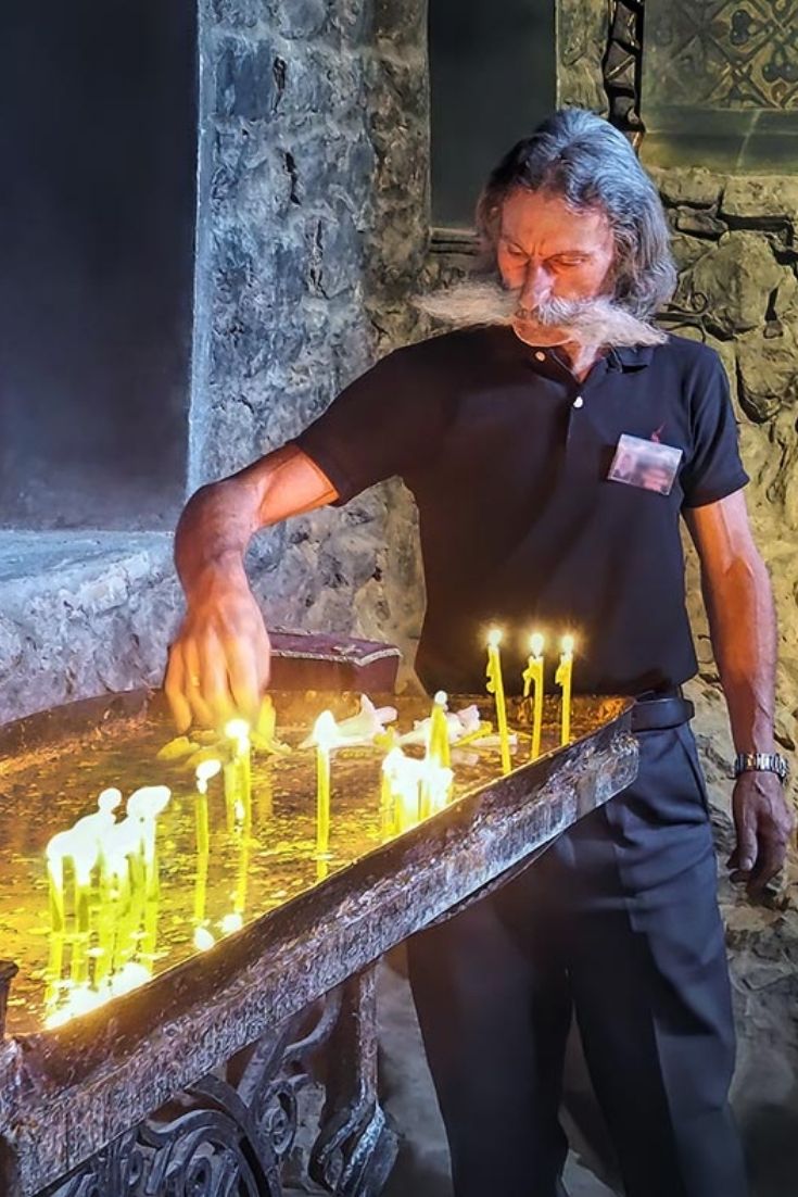 PHOTO: Pilgrim Lights a Candle at Khor Virap Monastery in Armenia