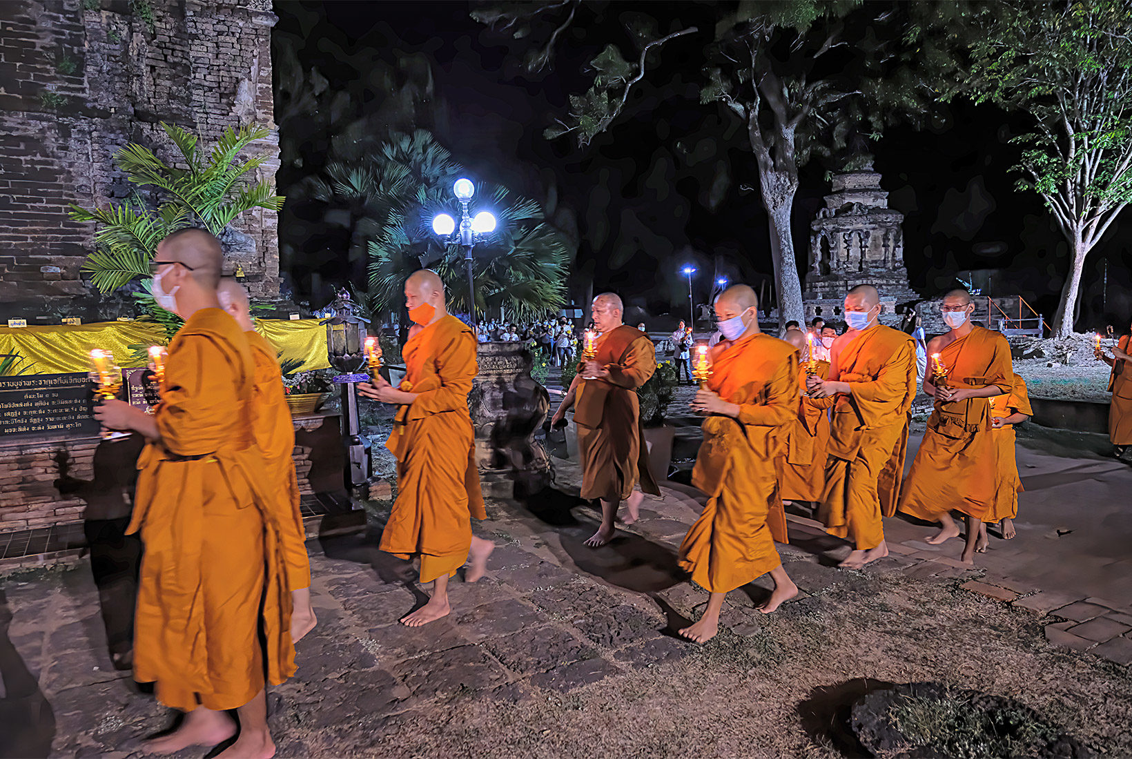 Monks lead a procession around the Viharn at Wat Jed Yod as part of the Makha Bucha Day ceremony