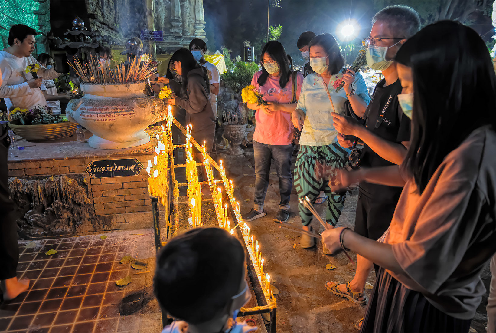 Worshipers light candles at Wat Jed Yod in Chiang Mai, Thailand, to pay respect to Buddha during Makha Bucha Day