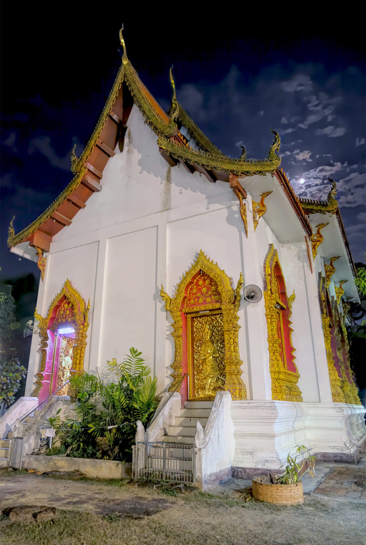 Full moon illuminates the Ubosot (Ordination Hall) at Wat Jed Yod in Chiang Mai, Thailand