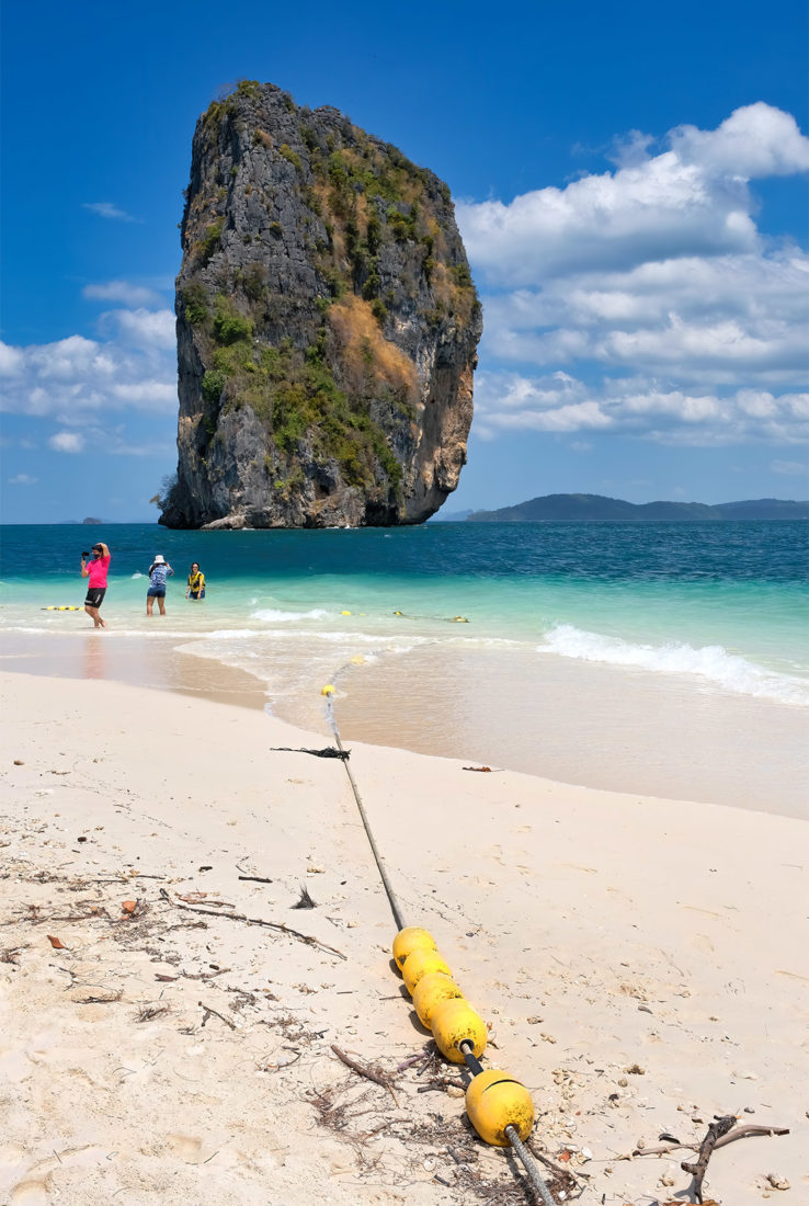 One of the most famous views in southern Thailand, the towering limestone stack offshore from Poda Island